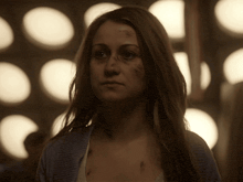 a woman with a bruise on her forehead is looking at the camera