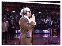 a man in an american flag costume stands on a basketball court in front of a sign that says 15