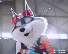 a husky mascot wearing sunglasses and a colorful shirt