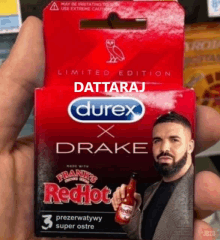 a man holding a box of durex x drake red hot condoms