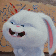 a white rabbit with a pink ear is standing in front of a yellow wall with drawings on it