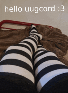 a person wearing black and white striped socks is laying on a bed with the words hello uugcord : 3 above them