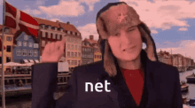 a man wearing a hat and a suit says net