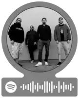 a group of men are standing in front of a brick wall with a spotify icon below them