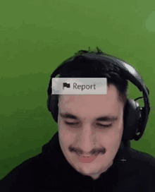 a man wearing headphones and a report button on his forehead