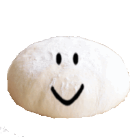 a smiley face is drawn on a piece of white dough