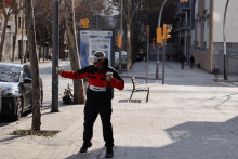 a man wearing a virtual reality headset stands in front of a sign for llum bcn