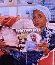 a woman is sitting on a couch reading a magazine called hmmph