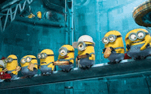 a group of minions are standing on a conveyor belt .