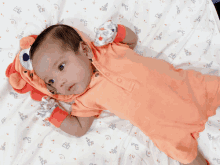 a baby is laying on a bed wearing a lion costume