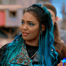 a woman with blue hair is wearing a sequined vest