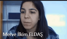 a close up of a woman 's face with the name merve ilkim eldas written above her