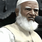 a man with a beard is speaking into a microphone with a white hat on