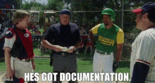 a group of baseball players standing on a field with the words `` he 's got documentation . ''