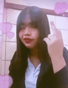 a girl with red lips is making a middle finger sign