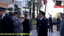 a group of men in military uniforms are standing in front of a building that says event makers productions on the bottom