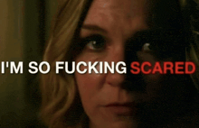 a close up of a woman 's face with the words " i 'm so fucking scared " behind her