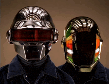 two men wearing futuristic helmets are standing next to each other in front of a brown background