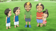 a group of children are standing in a grassy field and one is crying