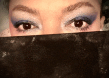 a close up of a woman 's eyes behind a black veil