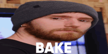 a man with a beard is wearing a beanie and the word bake is on his face