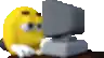 a yellow smiley face is sitting at a desk in front of a computer .