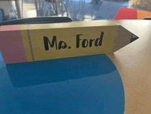 a wooden pencil with the name mrs. ford written on it