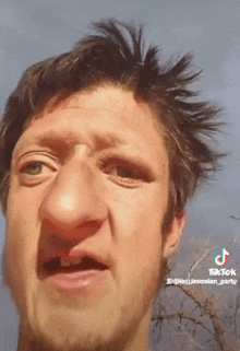 a man with a big nose is making a funny face with tiktok written on the bottom