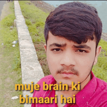 a young man in a pink shirt with the words moje brain ki bimaari hai written on the bottom