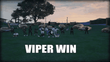 a group of people standing in a grassy field with the words viper win written on the bottom