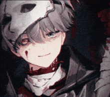 a boy is wearing a white mask and has blood on his face .