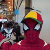 a man in a spiderman costume with a colorful hat on