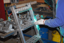 a person is welding a metal ladder with a green light coming out of it