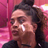 a woman wipes her eyes with a tissue
