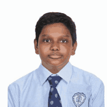 a young boy wearing a striped shirt and tie has a badge on his chest that says ' chennai '