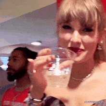 a woman drinking from a plastic cup that says swiffer pics on the bottom
