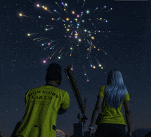 a man in a yellow shirt that says downtown cab co watches fireworks