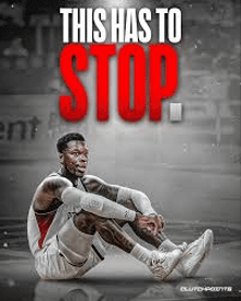a basketball player is sitting on the floor on the court .