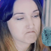 a close up of a woman making a face