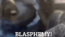 a close up of a person 's face with the words blasphemy written above it .