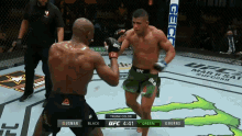 two men are fighting in a boxing ring with the ufc logo on the wall behind them