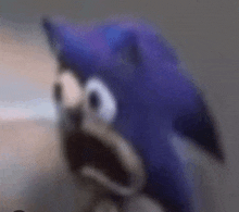 a close up of a sonic the hedgehog with his mouth open and a surprised look on his face .