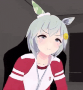 a girl with a flower in her hair is wearing a red and white jacket with a t on it