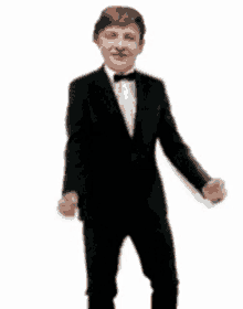 a young man in a tuxedo and bow tie is dancing .