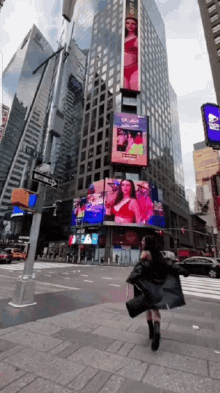 a woman is walking down a street in front of a building that has a sign that says one way