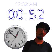 a man stands in front of a clock that says 2:52 am 00 52