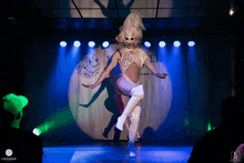 a drag queen performs on a stage with a sign that says lavender