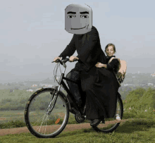 a man in a black robe is riding a bike with a girl on the back .