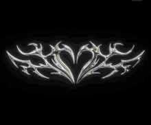 a black background with a silver design on it that looks like a heart