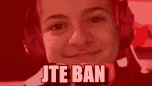 a man wearing headphones is smiling with the words jte ban above him